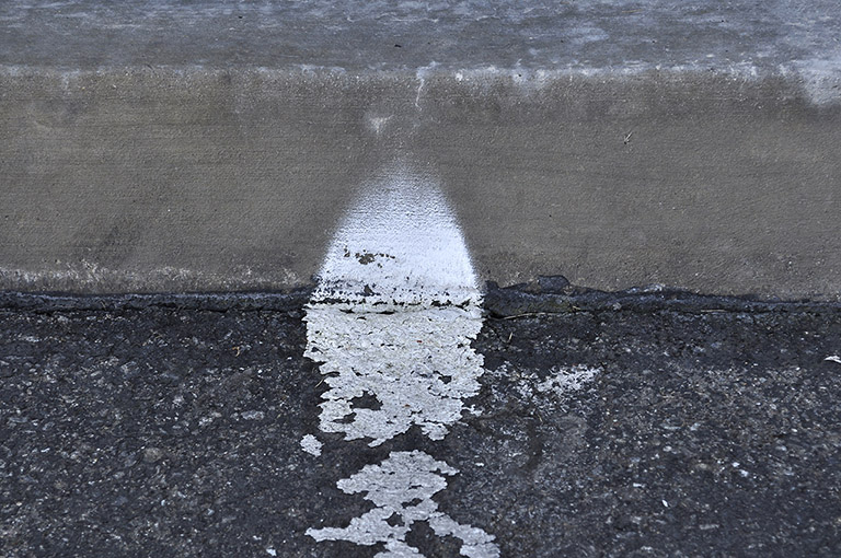Broken Tech Spray Paint Curb